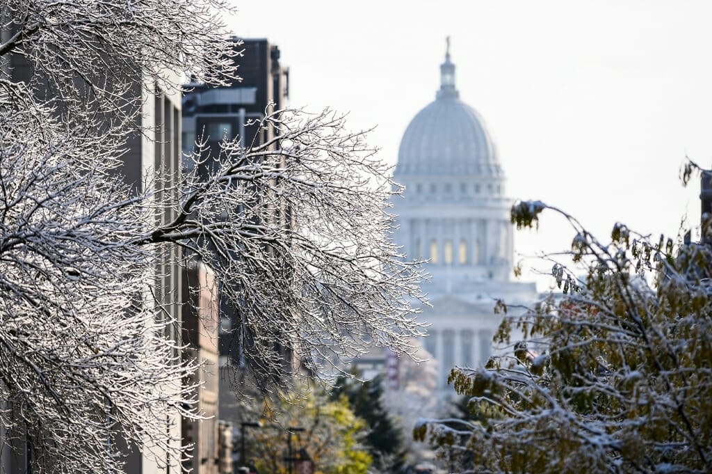Photo: The Capitol dome framed by snow covered branches.