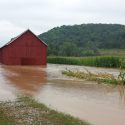 Photo: A field and barn are filled with water.