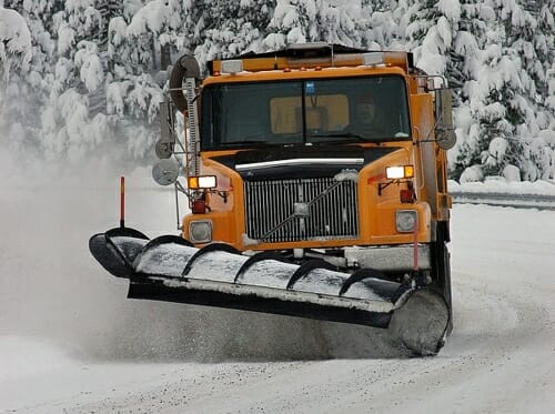 A snow plow clears snow