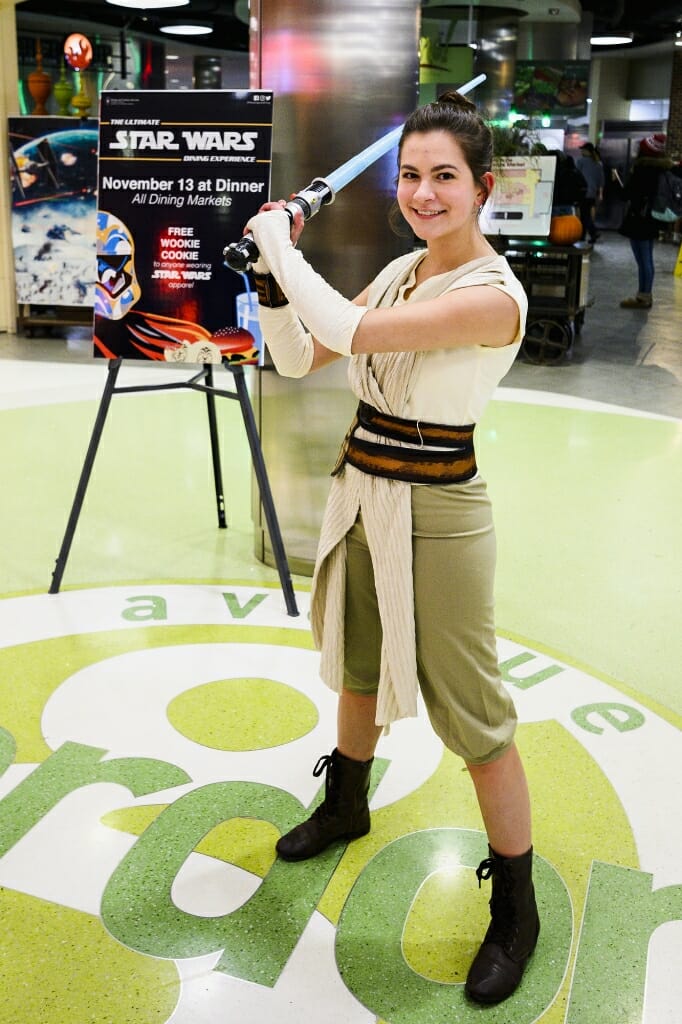 Dressed in costume as Rey, first-year student Lauren Jenny strikes a Jedi pose.