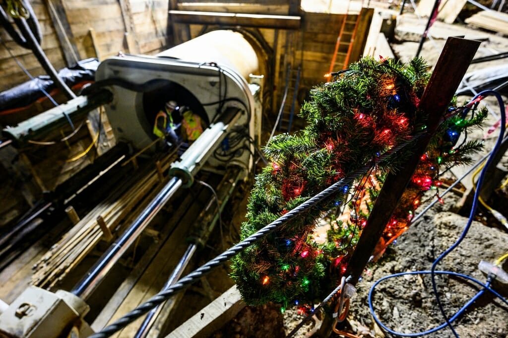 A wreath decorates some construction equipment in a pit.