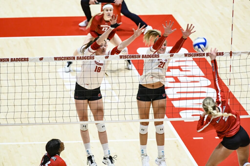 Photo: Danielle Hart (18) and Grace Loberg (21) go up for the block.