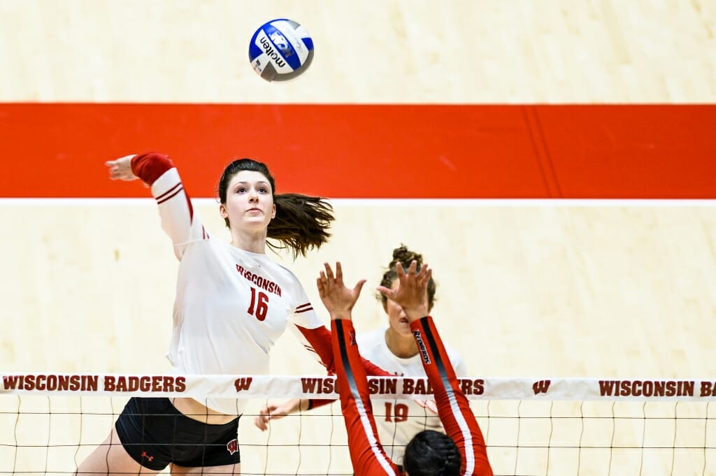 Photo: Dana Rettke (16) goes up to spike the ball.