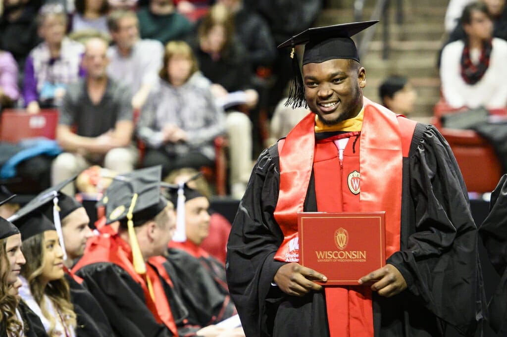 Photo of Chris Orr holding his diploma cover.
