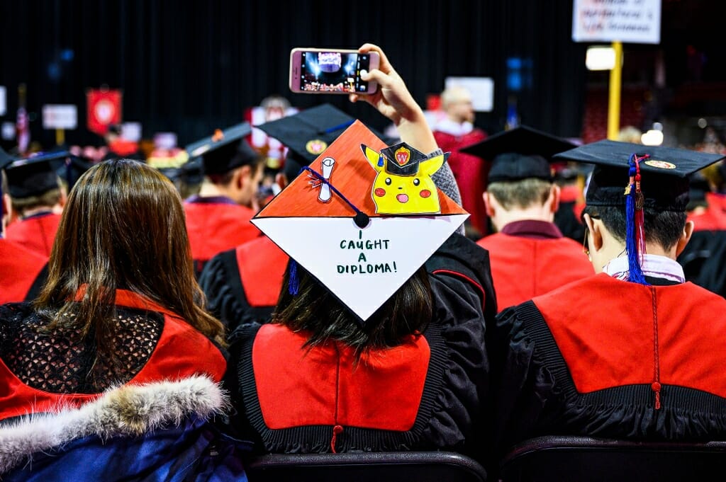 Photo of mortarboard with a cutout of Pokemon and the words "I caught a diploma."