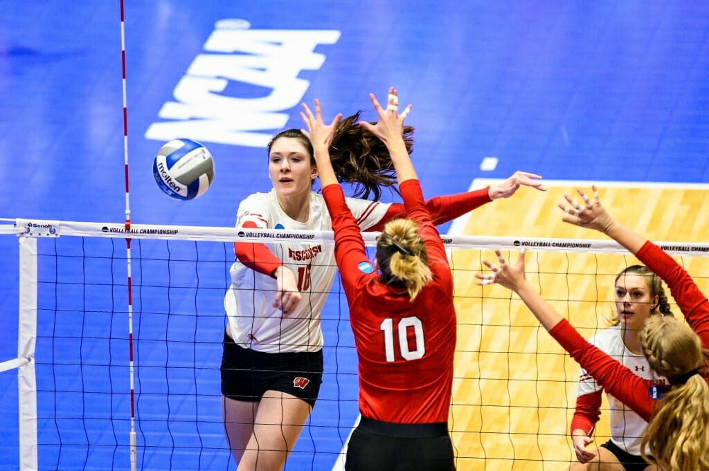 Photo: Wisconsin middle blocker Dana Rettke (16) eyes an opening and spikes the ball.