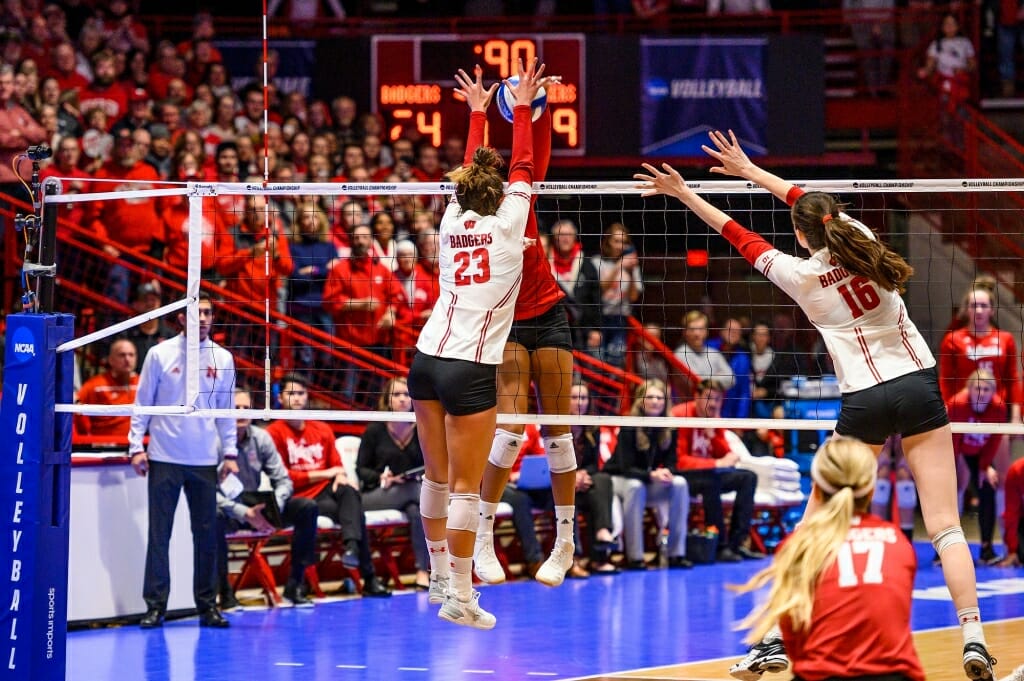 Photo: Wisconsin outside hitter Molly Haggerty (23) blocks the ball at the net and scores the winning point in the third set.