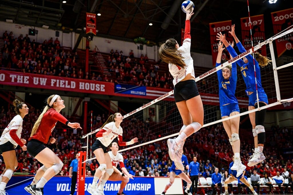 Photo: Wisconsin hitter Madison Duello (14) taps the ball over the net for a point.