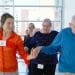 Photo: Student and older adult holding hands in a ballroom dance step
