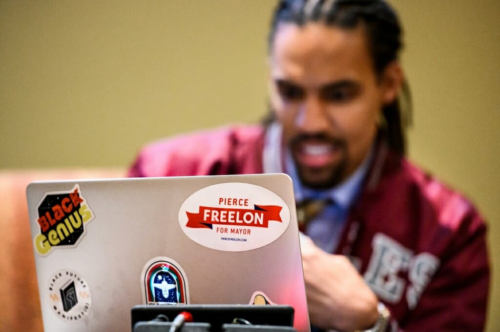A sticker on keynote speaker Pierce Freelon's laptop computer referred to his experience in 2017 running for mayor of the City of Durham.