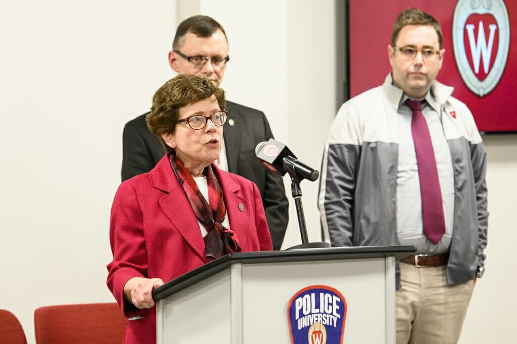 Chancellor Rebecca Blank speaks during a press conference addressing the COVID-19 (coronavirus) measures being taken by UW–Madison, which was held in the UW Police and Security Facility. She is accompanied by Jake Baggott, executive director of University Health Services (rear) and Laurent Heller, vice chancellor for finance and administration.
