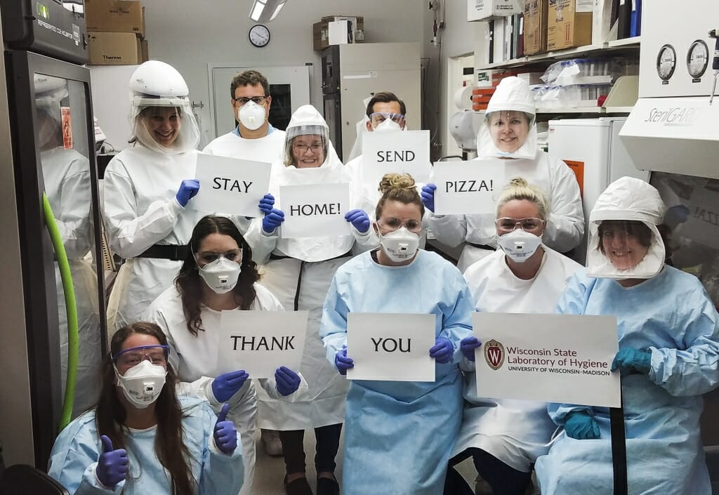 Workers at the Wisconsin State Laboratory of Hygiene show their gratitude for the free pizza delivery from 