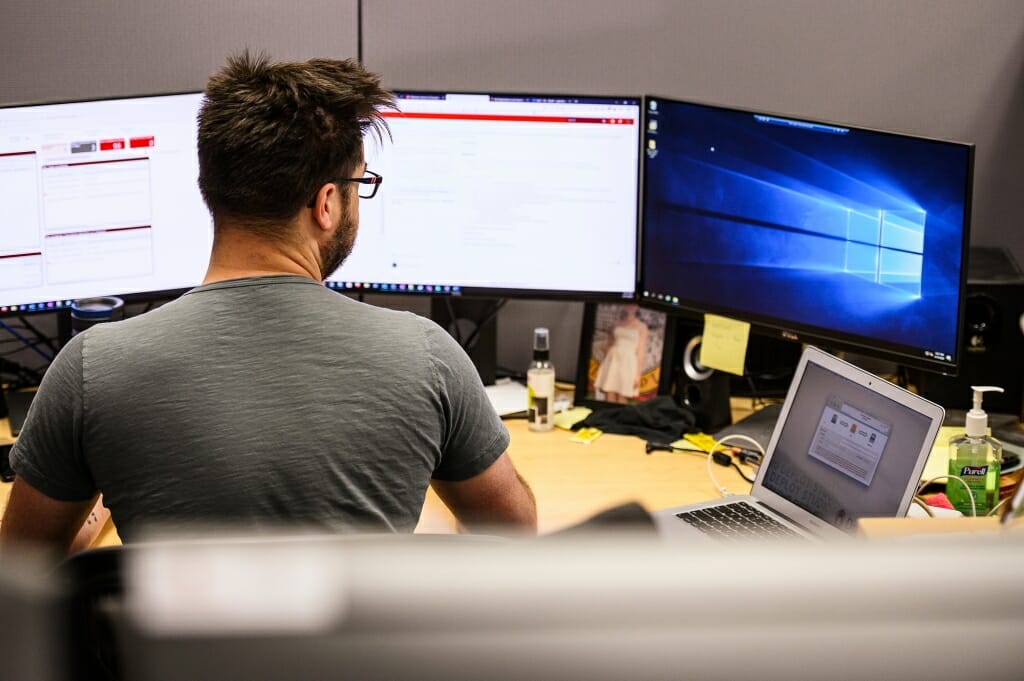 A man works at a computer screen.