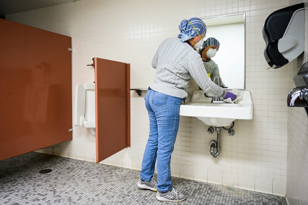 A person cleans a sink.