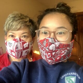 Two women wearing UW-themed face masks