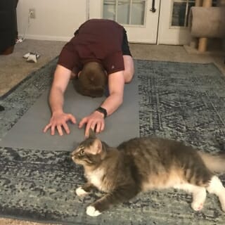 Then, he cooled down by doing some yoga with a furry friend.