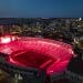 Photo: Camp Randall from above at night, with red lights illuminating it.