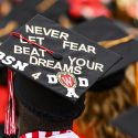 A UW graduate displays a personal message on their cap during UW-Madison's spring commencement ceremony at Camp Randall Stadium at the University of Wisconsin-Madison on May 11, 2019. The outdoor graduation was attended by over 7,000 bachelor’s, master’s and law student degree candidates, plus their guests. (Photo by Bryce Richter /UW-Madison)