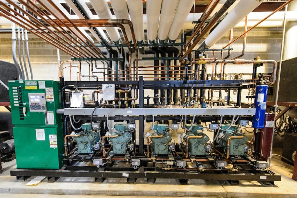 Comlicated refrigeration equipment is pictured with many pipes leading from it.