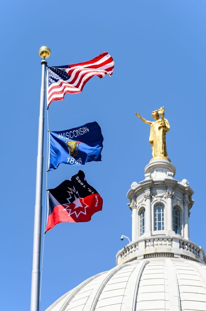 The Juneteenth flag, flying below the American and State of Wisconsin flags commemorates the day the last group of enslaved Black Americans were made aware of their liberation in Galveston, Texas in 1865 — more than two years after the Emancipation Proclamation.