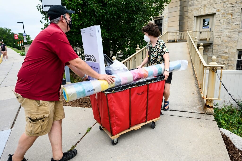 Todd Rosenberg and his daughter Bella roll her belongings up a ramp into Elizabeth Waters Residence Hall.