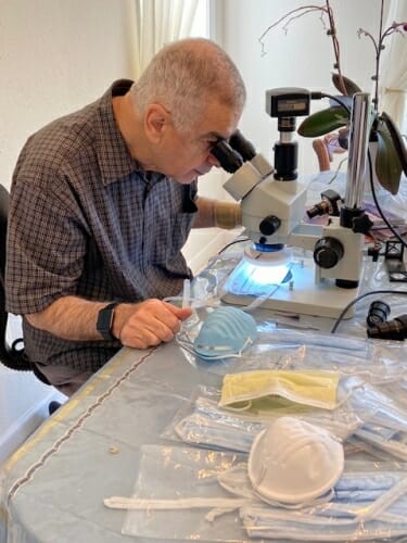 Textile chemist Majid Sarmadi examines sample masks while choosing material for a UW–Madison-designed face-covering.