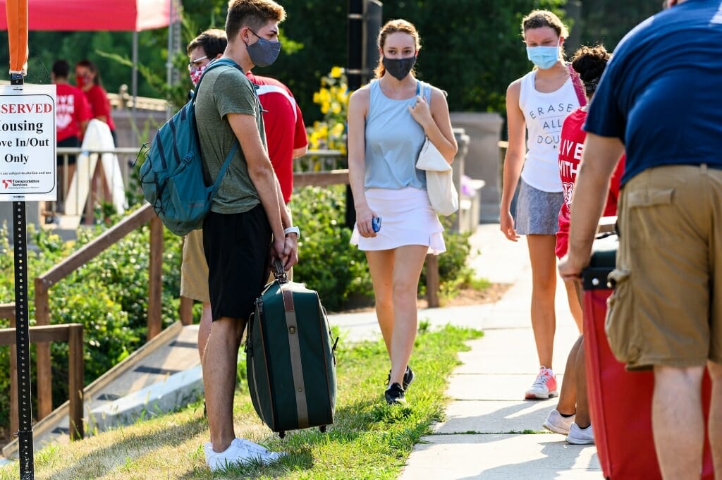 Students greet each other as they move in to Elizabeth Waters Residence Hall.
