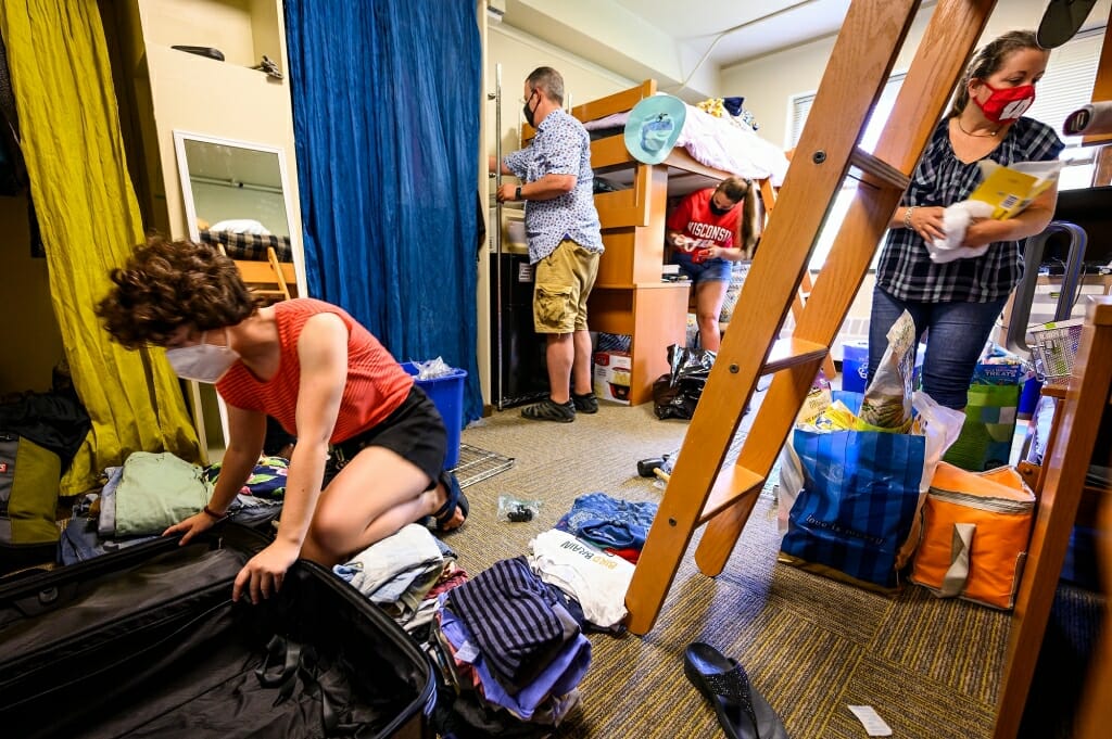 Student Bella Rosenberg, left, from Chicago, unpacks as her parents Todd Rosenberg and Stacey Raube help her move in to Elizabeth Waters Residence Hall.