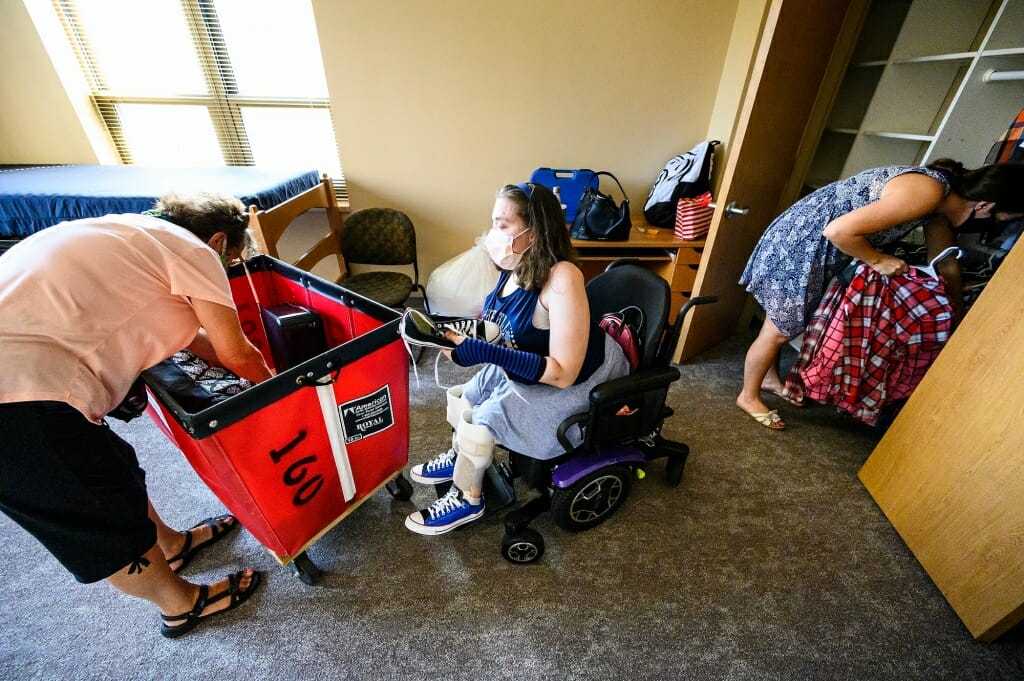 Maria Pesick of Wales, Wis., moves into a single-person room in Smith Residence Hall. Helping unpack is Maria’s grandmother Terry McCabe, at left, and mother, Lisa Pesick, at right.