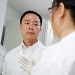 Su-Chun Zhang in his lab listening to a researcher