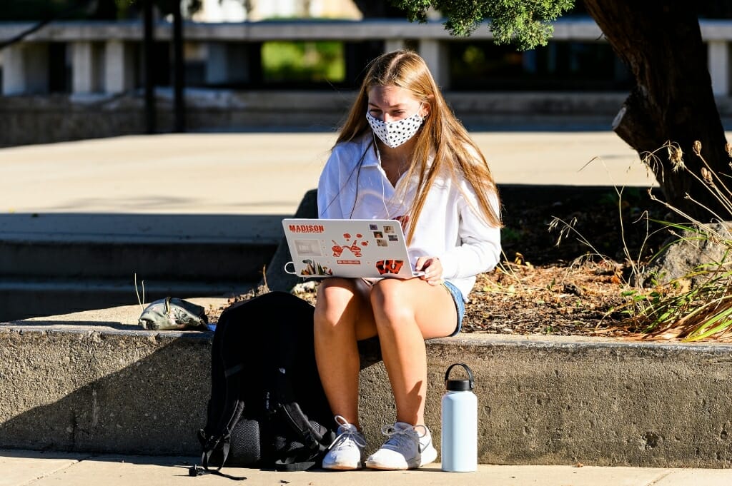 Lauren Gitzlaff, a first-year student from Brookfield, Wis., works on her computer laptop outside Van Vleck Hall.