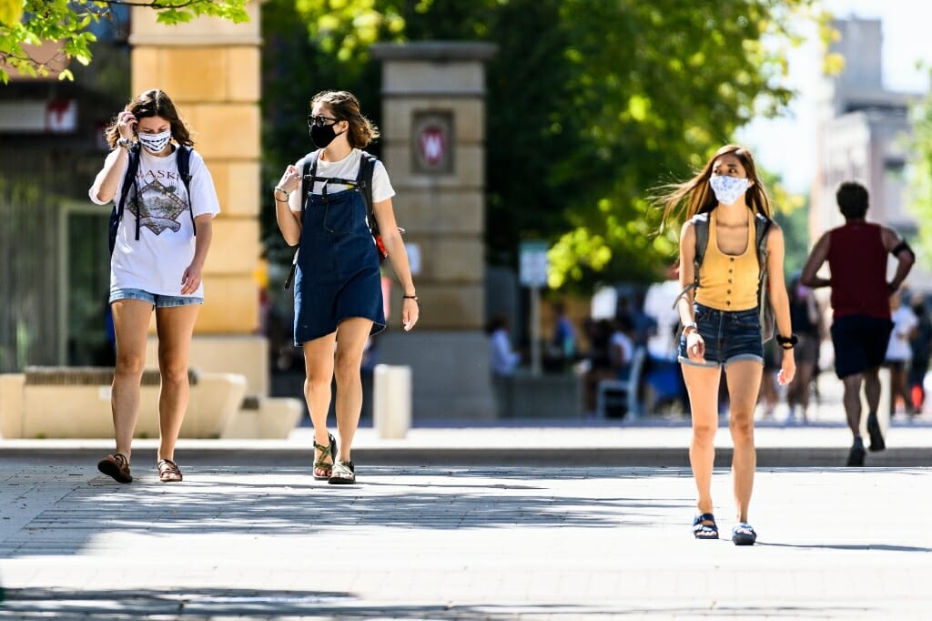 Pedestrians walk along East Campus Mall during the first day of classes.