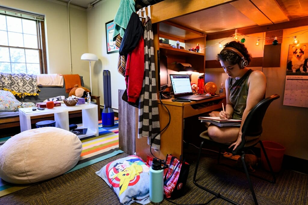 Bella Rosenberg, a first-year student from Chicago, takes notes as part of her virtual calculus class while she studies in her room at Elizabeth Waters Residence Hall.