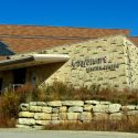 Exterior of main entrance to visitor center with rock wall and native plants