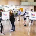 Students cast their ballots in physically distanced voting booths at the Chazen Museum of Art polling station on Nov. 3, 2020.