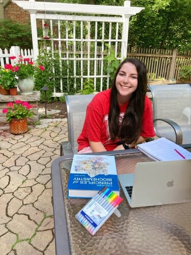 Lisa Klein sitting at a table on a patio