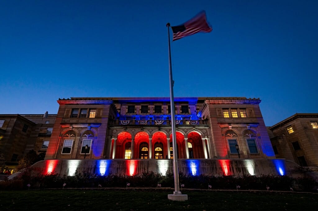 Memorial Union illuminated in red, white and blue lights