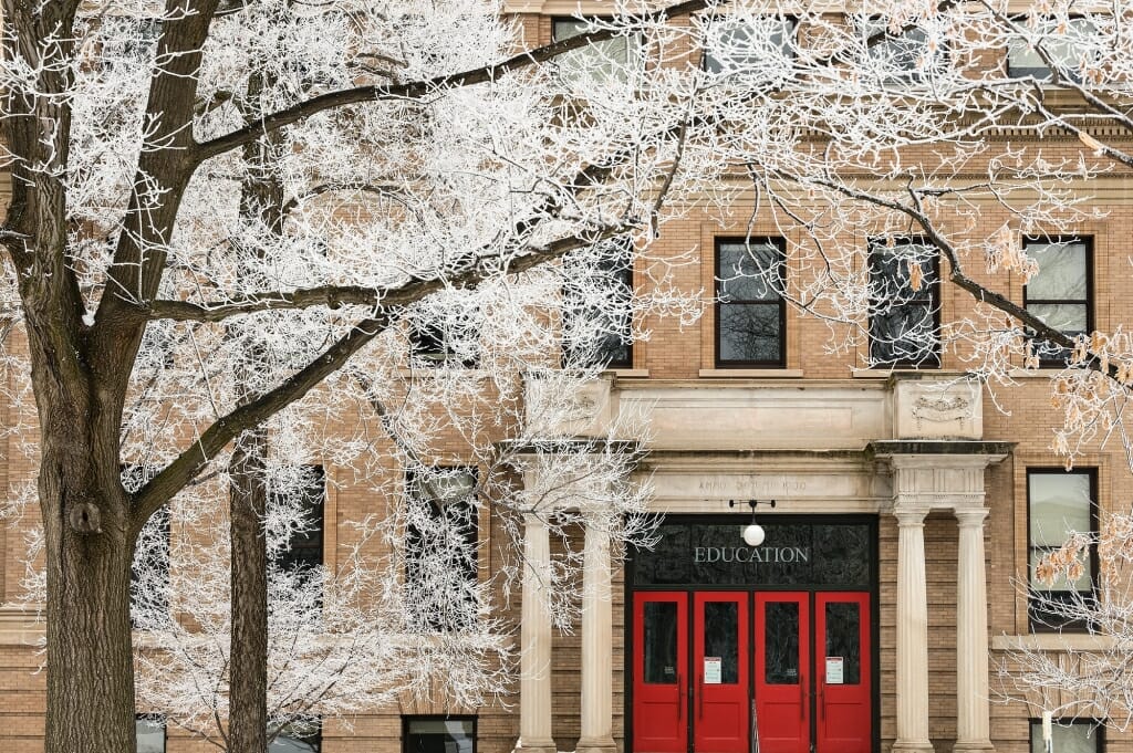 Icy tree branches contrast nicely with the iconic red entry doors of the Education Building.