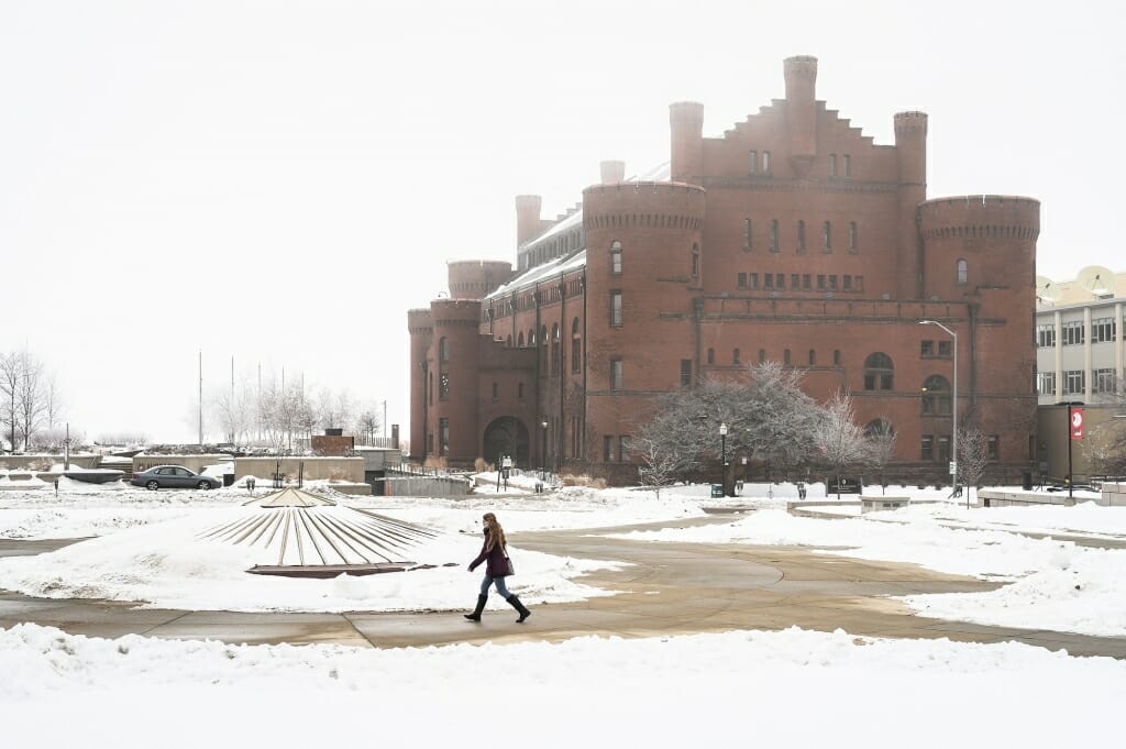 A pedestrian walks through Library Mall on a foggy winter day on Jan. 7, with the Red Gym in the background. 