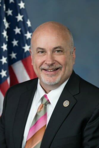 Portrait of Mark Pocan in front of an American flag