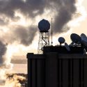 Satellite dishes and meteorological instruments atop the Atmospheric, Oceanic and Space Sciences Building are seen is silhouette during a frigid, subzero winter sunrise on Feb. 7.