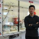 Portrait of Tang posing in his lab