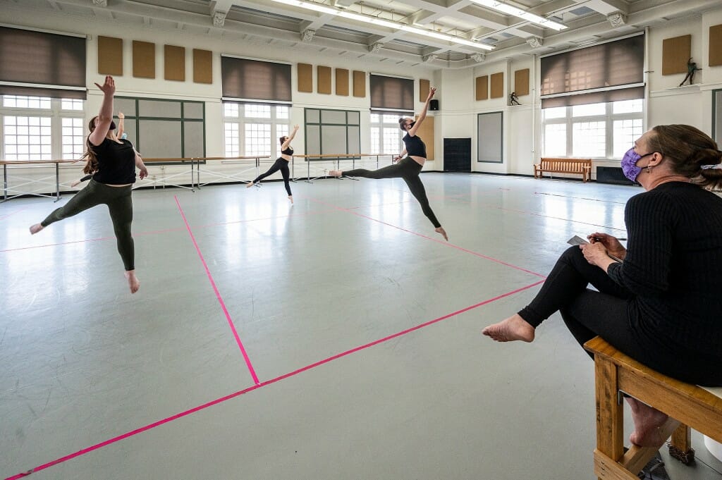 Students perform within their designated 10-feet by 12-feet rehearsal sections during Dance 112: Contemporary Dance Technique and Theory II. The in-person class is taught by faculty associate Karen McShane-Hellenbrand, seated at right, in Lathrop Hall on April 23.