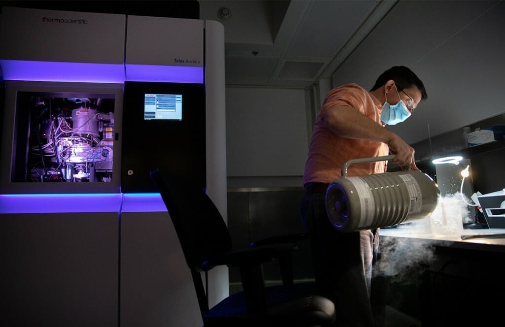 Eric Montemayor loading samples into the Thermo Scientific Talos Arctica cryo-transmission electron microscope (cryo-TEM) at the center’s secondary facility