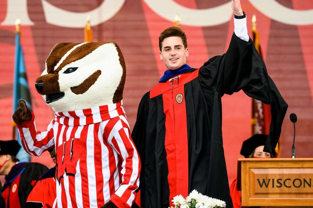 Photo of Reuvers waving to the crowd with Bucky.