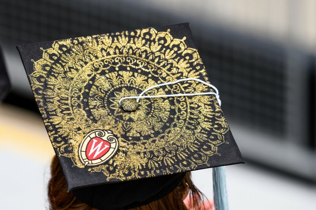 A mortarboard decorated with an intricate gold circular pattern
