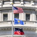 Photo of the red, white and blue Juneteenth (lowest below the American and State of Wisconsin flags) flying at the Wisconsin state capitol
