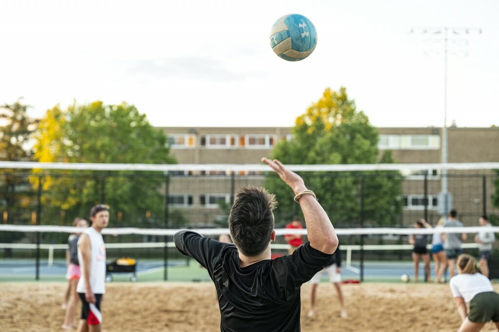 A student tosses up a serve.