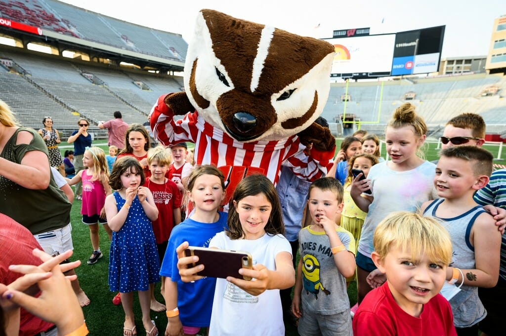 Children pose for a selfie with Bucky before the movie starts.