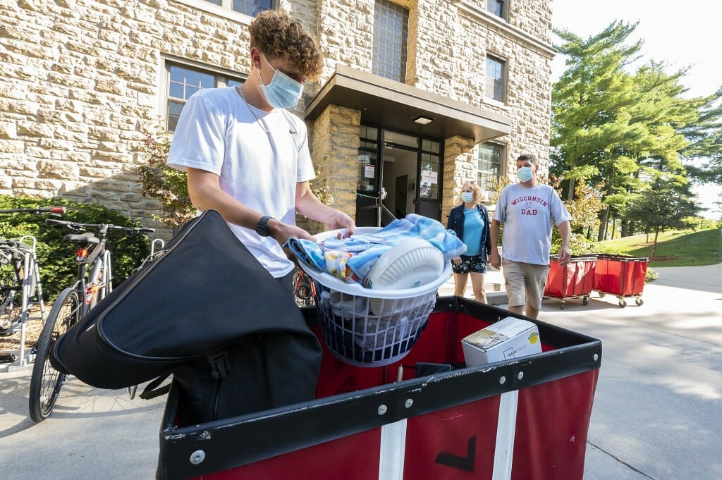 Student Tyler Demmith and his family have their hands full during move-in.